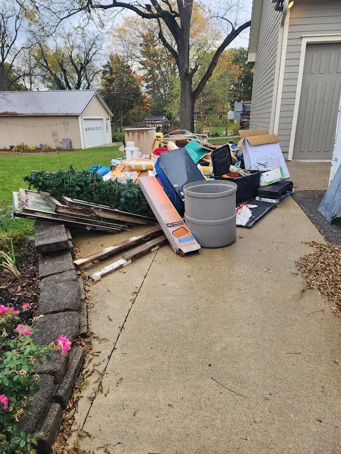 Dumpster being loaded with debris for 12 Yard Dumpster Rental in Parker